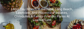 Labor Day brunch spread at Loaded Café with avocado toast, fresh fruit, sauces, and pineapple on a rustic wooden table