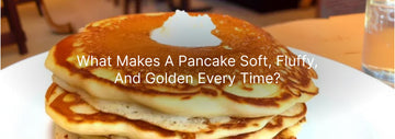 Stack of fluffy golden-brown pancakes topped with melting butter on a white plate