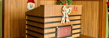 Festively decorated wooden counter with a “LOADED” sign, holiday bow, and Santa-themed wall decor in the background.