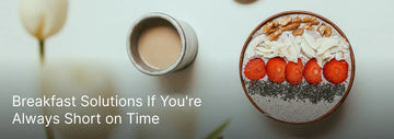 a smoothie bowl topped with strawberries, chia seeds, coconut flakes, and nuts beside a cup of coffee, with the text “Breakfast Solutions If You’re Always Short on Time.”