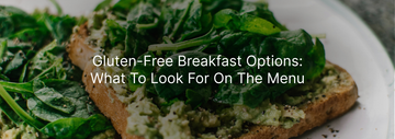 Close-up of a gluten-free avocado toast topped with fresh spinach on a white plate, with text overlay reading "Gluten-Free Breakfast Options: What To Look For On The Menu