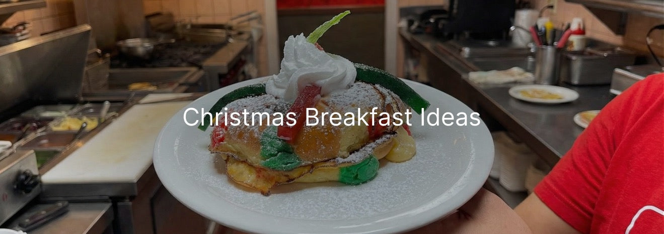 A plate of Christmas-themed French toast topped with whipped cream and red and green candy in a diner kitchen, with the text “Christmas Breakfast Ideas” overlaid