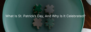 A plate with four green and white shamrock-shaped cookies, symbolizing St. Patrick's Day, set against a simple background.