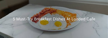 Plate of crispy hash browns and two sunny side up eggs on a marble table, with the text “5 Must-Try Breakfast Dishes At Loaded Cafe”