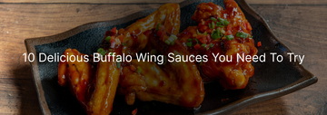 A close-up of buffalo wings served with a spicy sauce and garnished with chopped green onions, showcasing 10 different delicious buffalo wing sauces.
