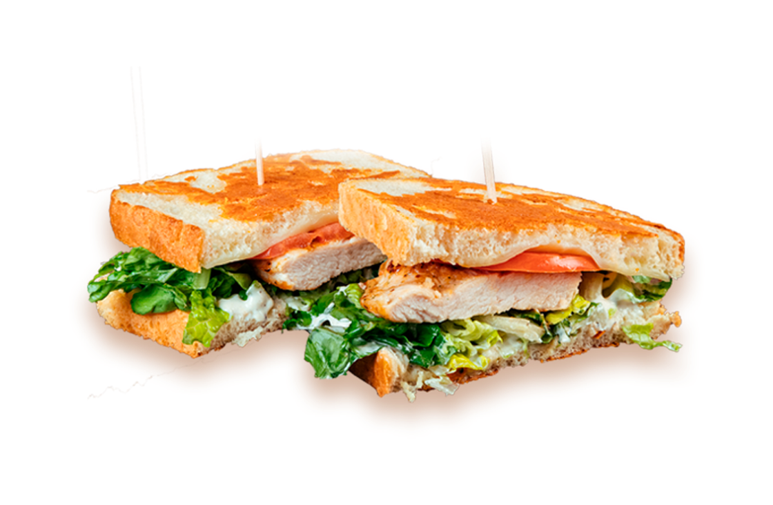 Grilled chicken sandwich with lettuce, tomato, and mayo served on toasted bread, held together with wooden skewers.